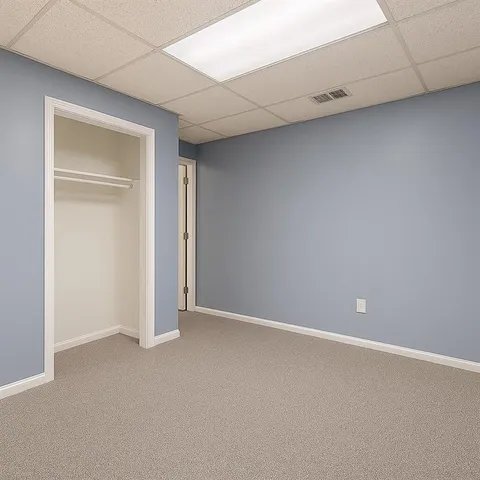 a bedroom with a bed and a desk