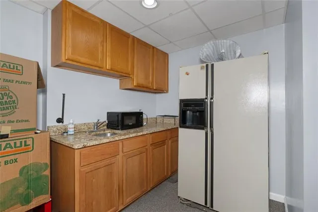 a front view of a house with a yard covered in snow