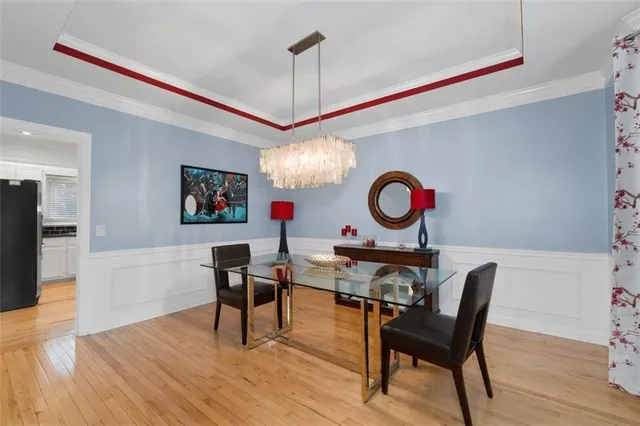 a view of a dining room with furniture wooden floor and chandelier