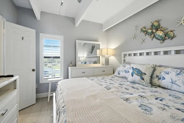 a bedroom with a large bed and a window