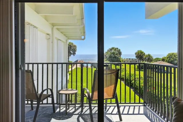 a view of a chairs and table in the balcony