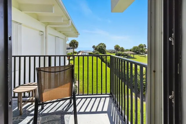 a view of a balcony with wooden floor