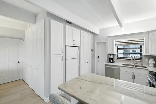 a kitchen with stainless steel appliances a refrigerator and a sink