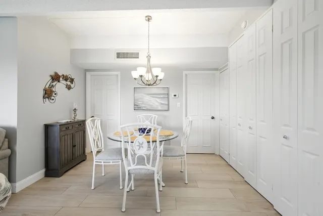 a view of a dining room with furniture and chandelier