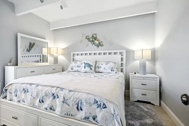 a bedroom with a bed and a painting on the wall