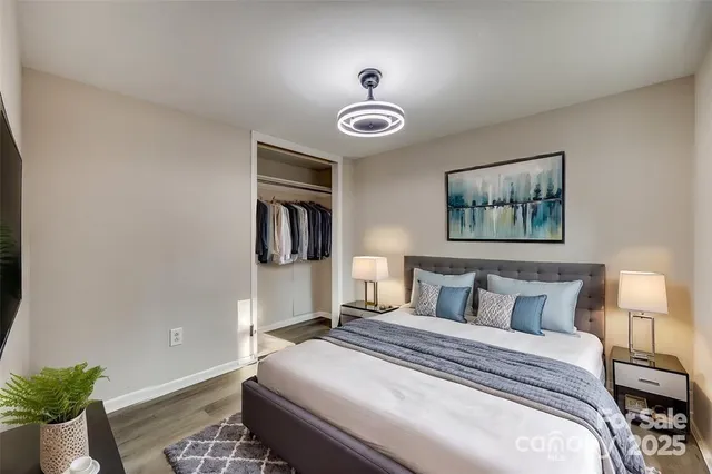 a bedroom with a bed and a chandelier