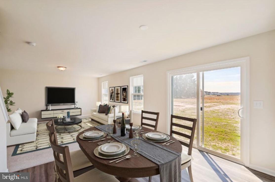 14 Patterson Lane Newark, DE 19702 - Photo 2 of 7 a living room with furniture a flat screen tv and a floor to ceiling window