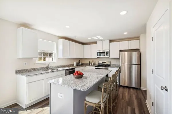 a kitchen with stainless steel appliances granite countertop a refrigerator sink and cabinets