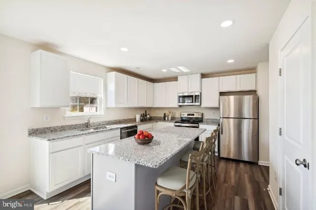 a kitchen with stainless steel appliances granite countertop a refrigerator sink and cabinets
