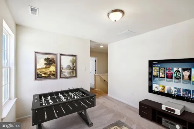 a view of a livingroom with furniture and book shelf