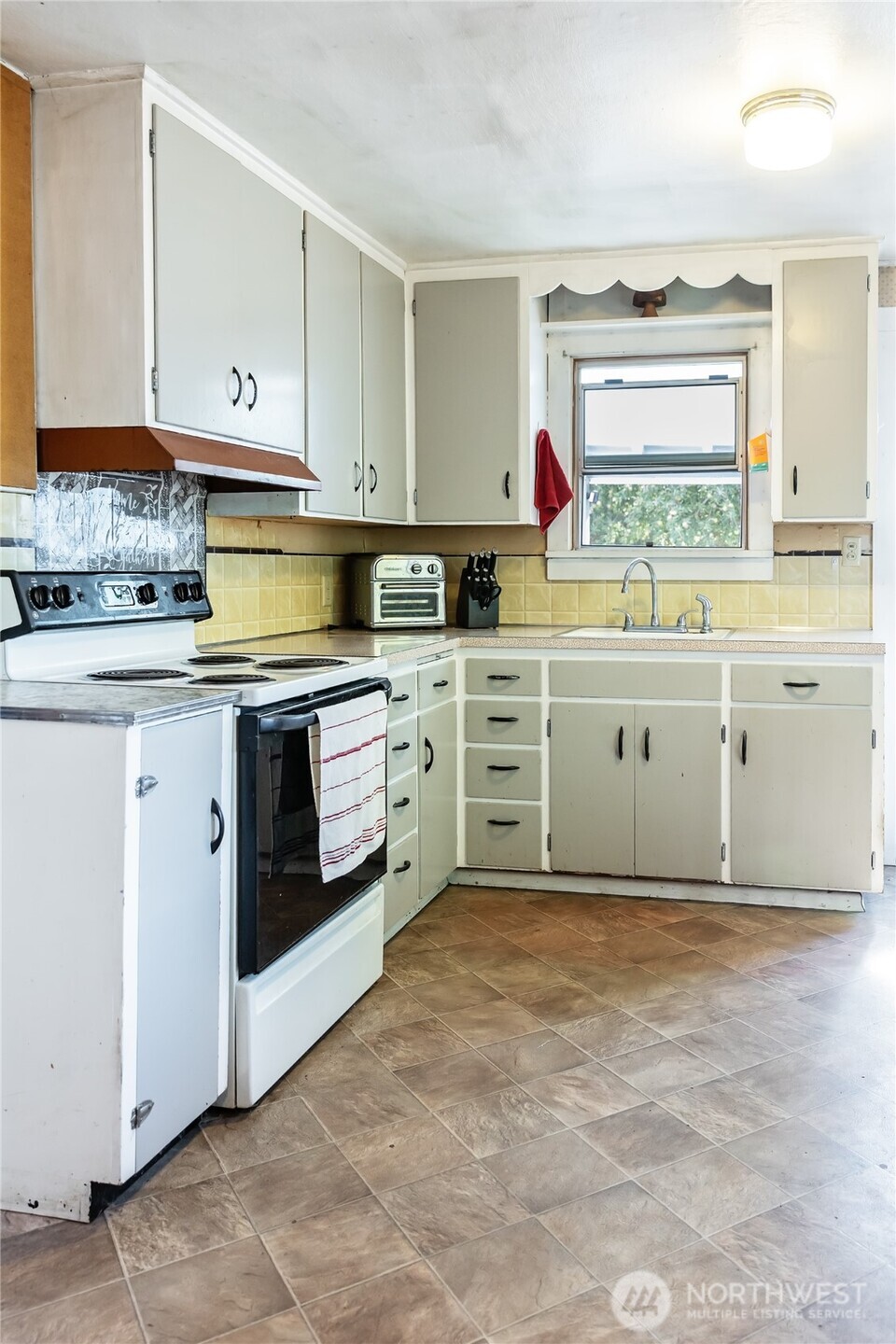 110 Strande Road Ellensburg, WA 98926 - Photo 12 of 39 a kitchen with granite countertop white cabinets white stainless steel appliances with a sink and dishwasher