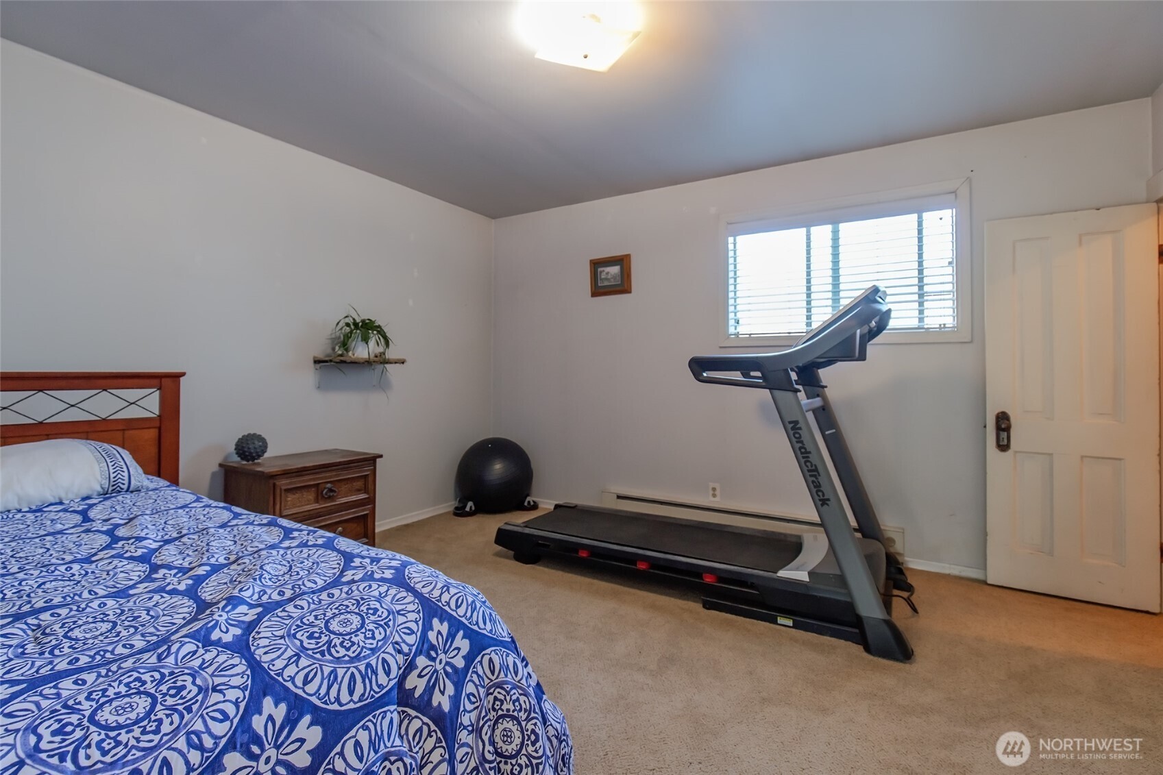 110 Strande Road Ellensburg, WA 98926 - Photo 22 of 39 a bedroom with a bed and a chandelier
