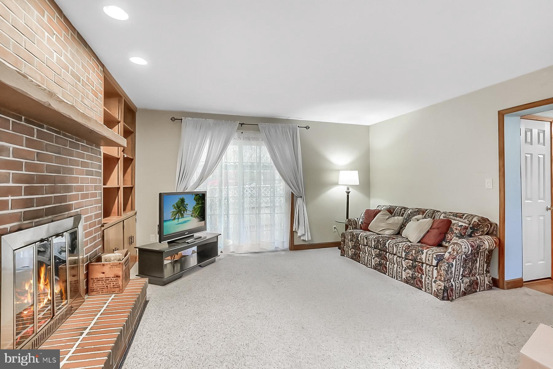 2011 Columbia Avenue Camp Hill, PA 17011 - Photo 13 of 33 a spacious bedroom with a bed a flat screen tv and a couch