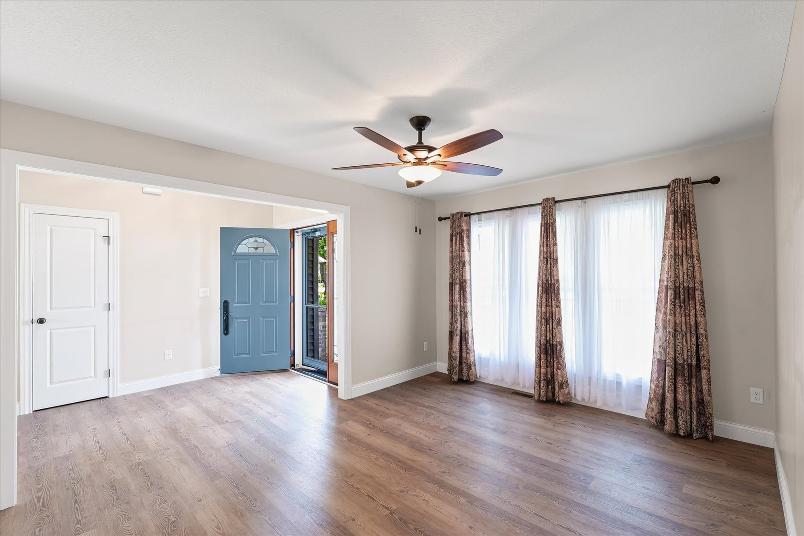103 1st Street Strawn, IL 61775 - Photo 12 of 50 an empty room with wooden floor and ceiling fan
