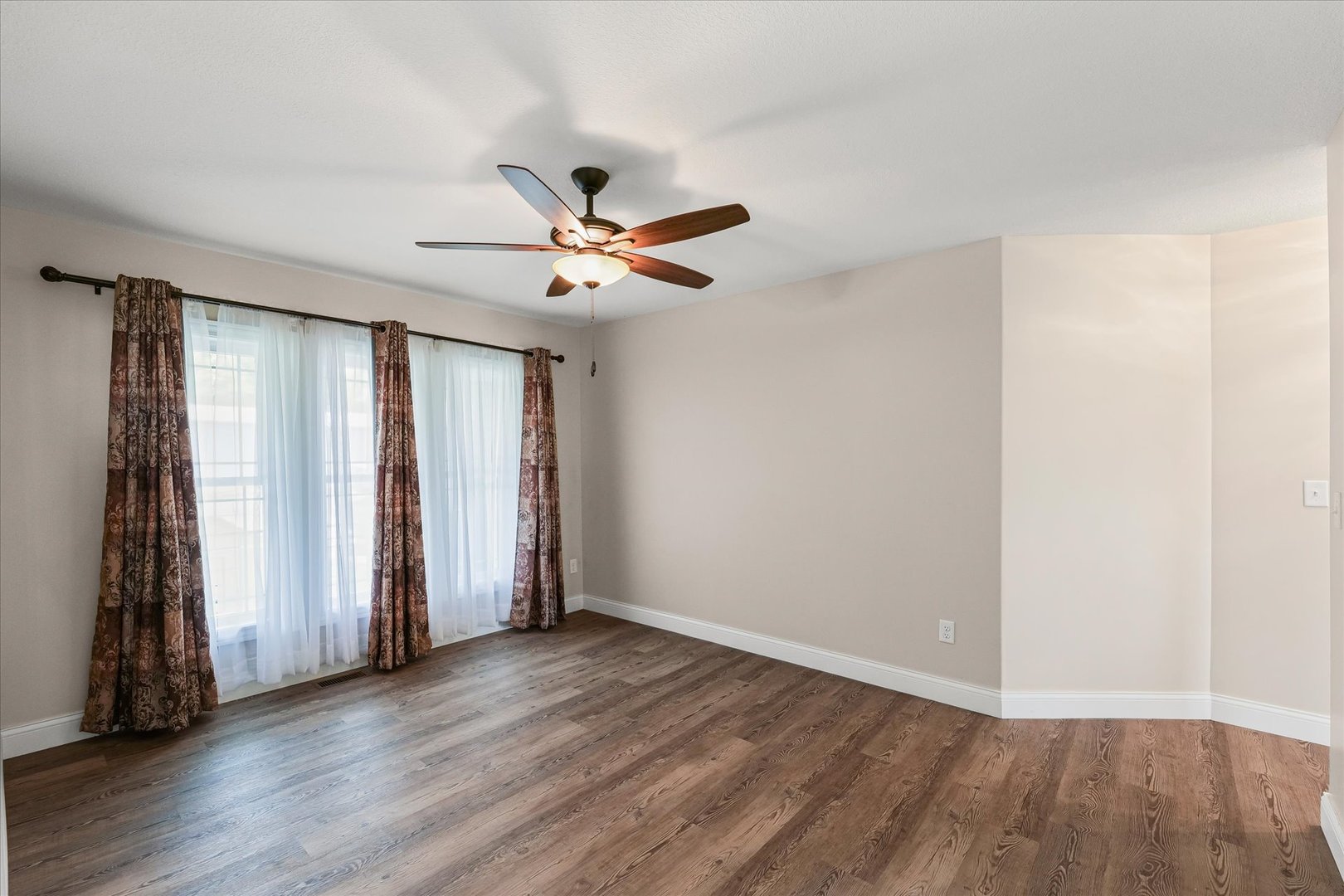 103 1st Street Strawn, IL 61775 - Photo 13 of 50 an empty room with wooden floor and windows