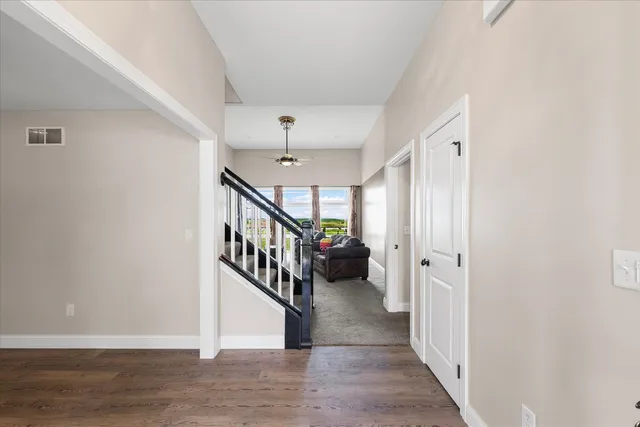 a view of an entryway with wooden floor and stairs