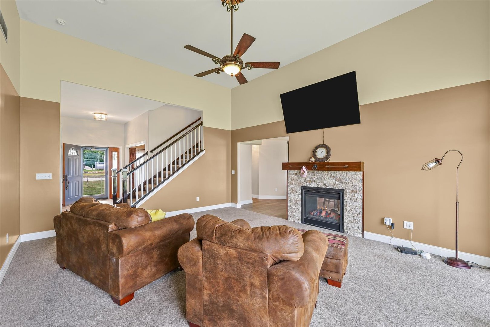 103 1st Street Strawn, IL 61775 - Photo 18 of 50 a living room with furniture a fireplace and a flat screen tv