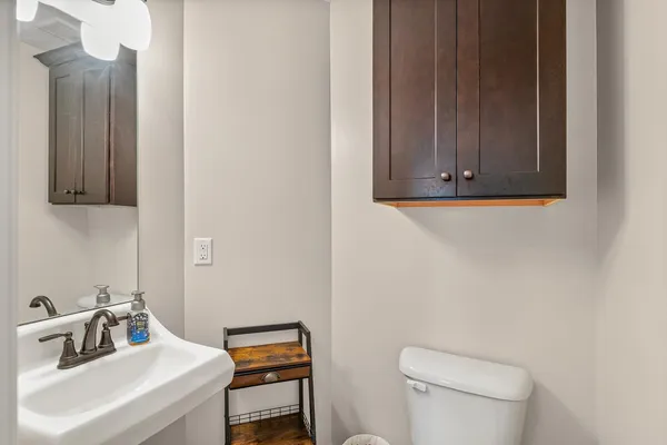 a bathroom with a sink a toilet and mirror