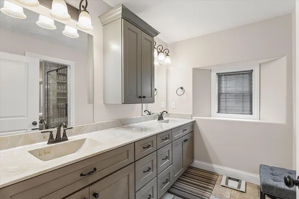 a bathroom with a sink double vanity granite and a mirror