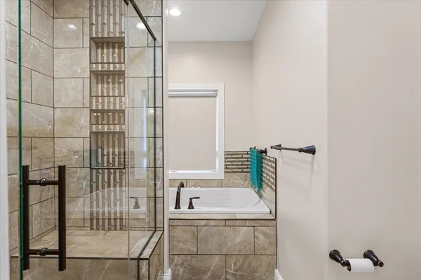 a bathroom with a tub and a shower