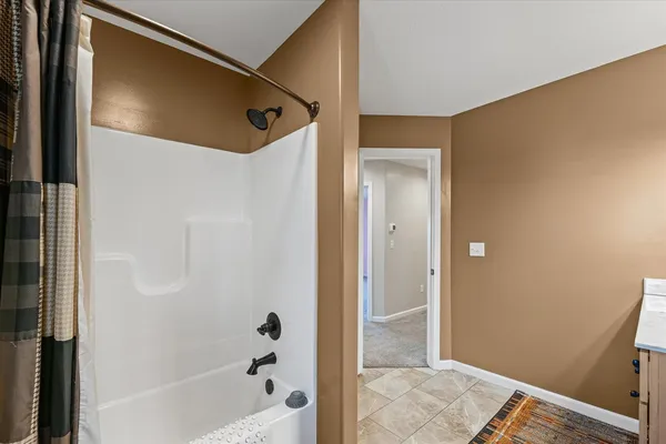 a bathroom with a tub and shower