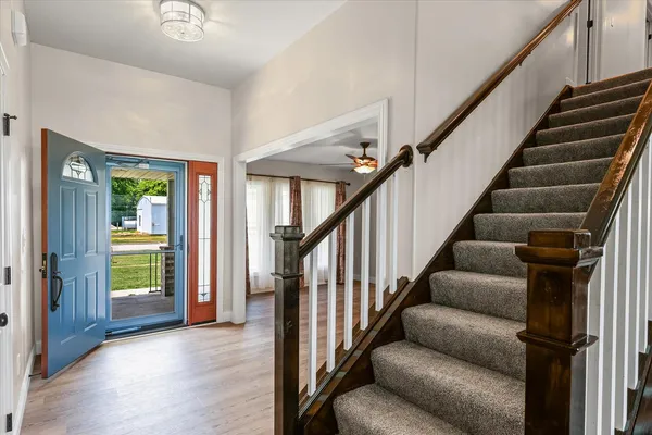 a view of entryway and hall with wooden floor