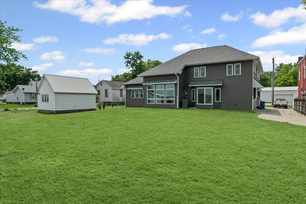 a front view of a house with a garden and yard