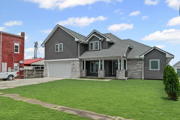 a front view of a house with a yard and garage