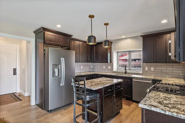 a kitchen with a stove a refrigerator and a sink