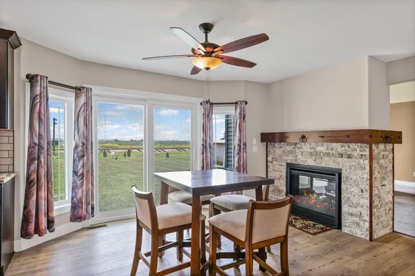 a dining room with furniture window and wooden floor