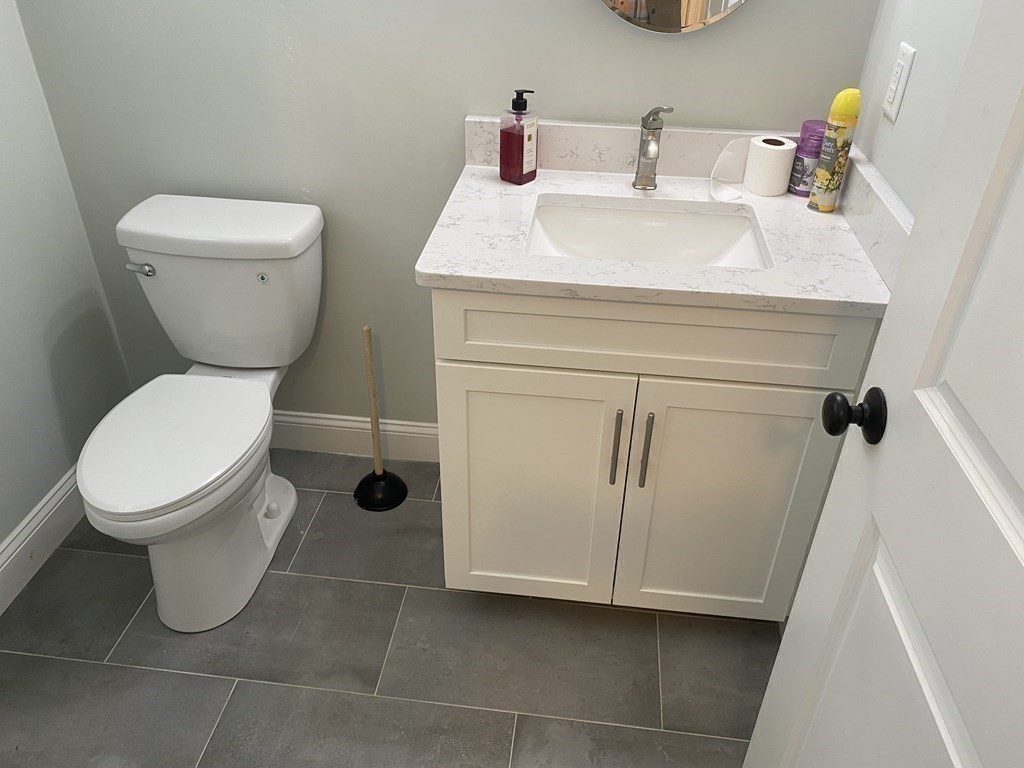 7 Marshall Street, Unit 7 Ayer, MA 01432 - Photo 12 of 31 a bathroom with a toilet sink and mirror