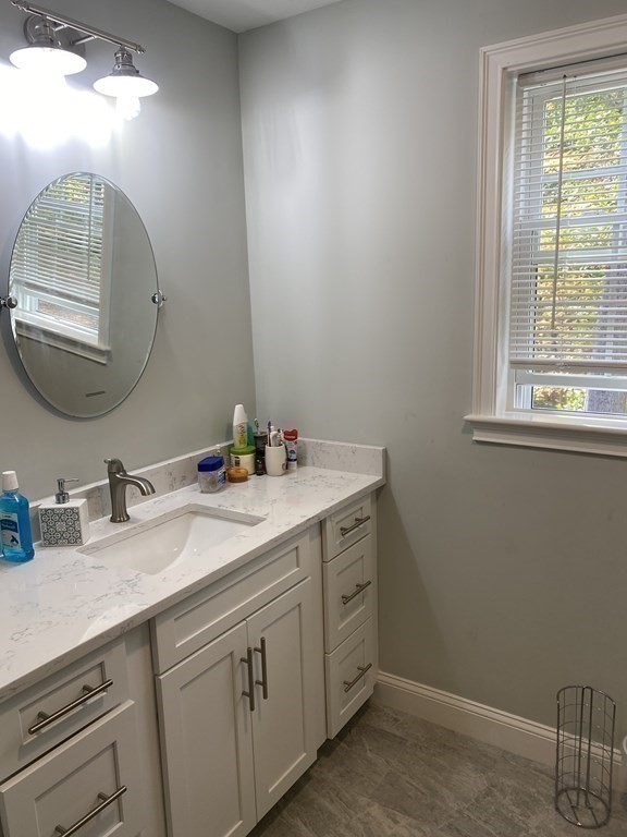 7 Marshall Street, Unit 7 Ayer, MA 01432 - Photo 14 of 31 a bathroom with a double vanity sink and a mirror