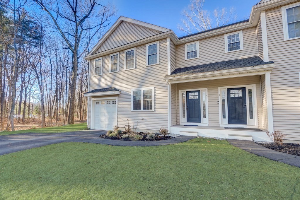 7 Marshall Street, Unit 7 Ayer, MA 01432 - Photo 2 of 31 a front view of a house with a yard