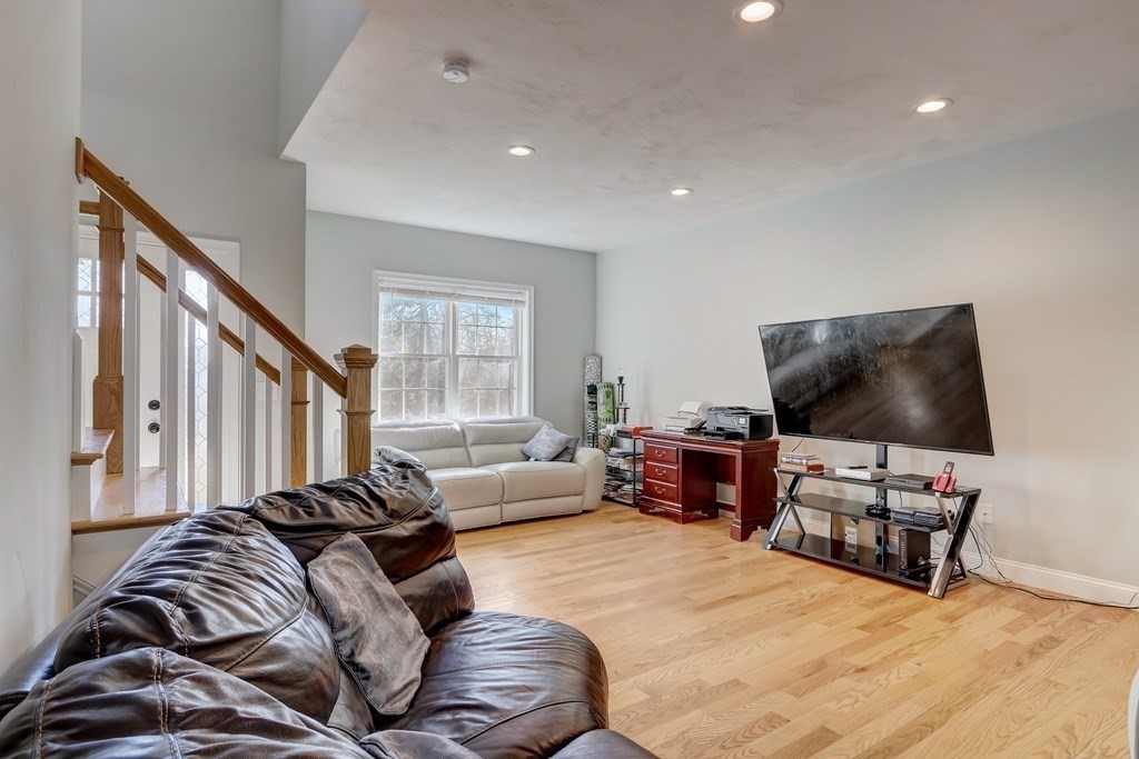 7 Marshall Street, Unit 7 Ayer, MA 01432 - Photo 23 of 31 a living room with furniture and a flat screen tv