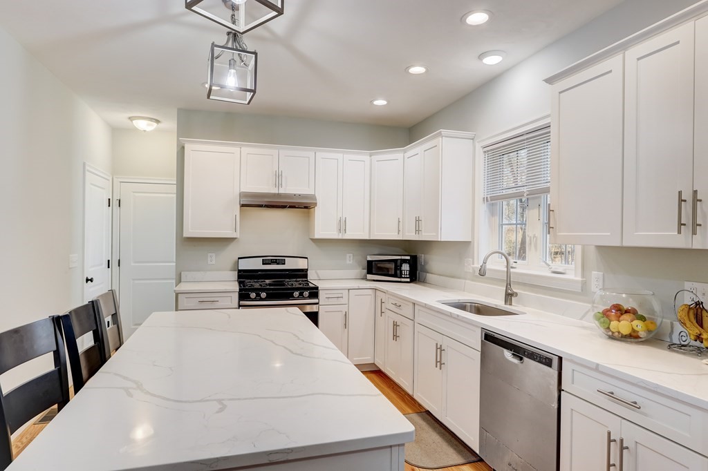 7 Marshall Street, Unit 7 Ayer, MA 01432 - Photo 26 of 31 a kitchen with stainless steel appliances a stove sink and cabinets