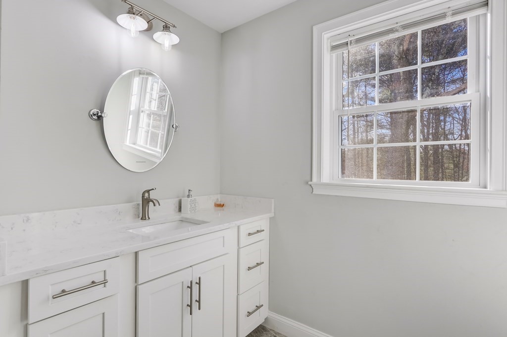 7 Marshall Street, Unit 7 Ayer, MA 01432 - Photo 30 of 31 a bathroom with a sink and a mirror