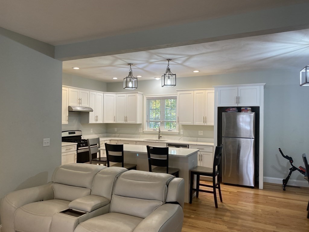 7 Marshall Street, Unit 7 Ayer, MA 01432 - Photo 10 of 31 a living room with stainless steel appliances kitchen island granite countertop a dining table chairs refrigerator and sink