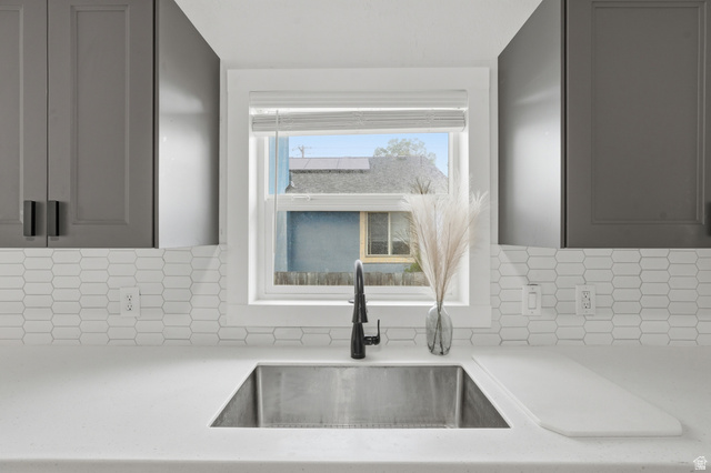 215 East 300 South Logan, UT 84321 - Photo 6 of 32 Kitchen featuring light stone counters and gray cabinetry