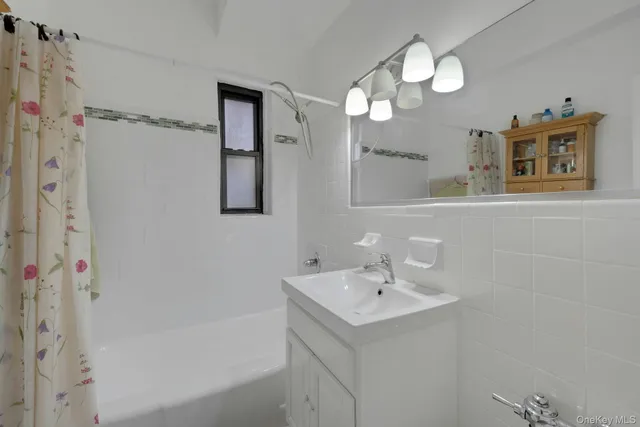 a bathroom with a sink a mirror and a shower