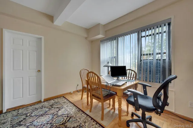 a view of a workspace with furniture and a window