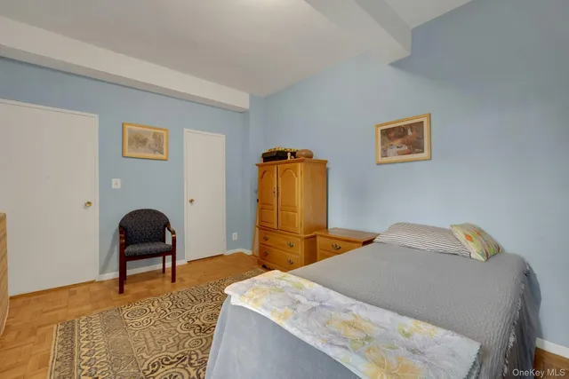 a bedroom with a bed and chair