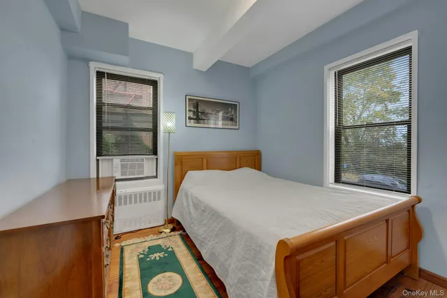a bed sitting in a bedroom next to a window