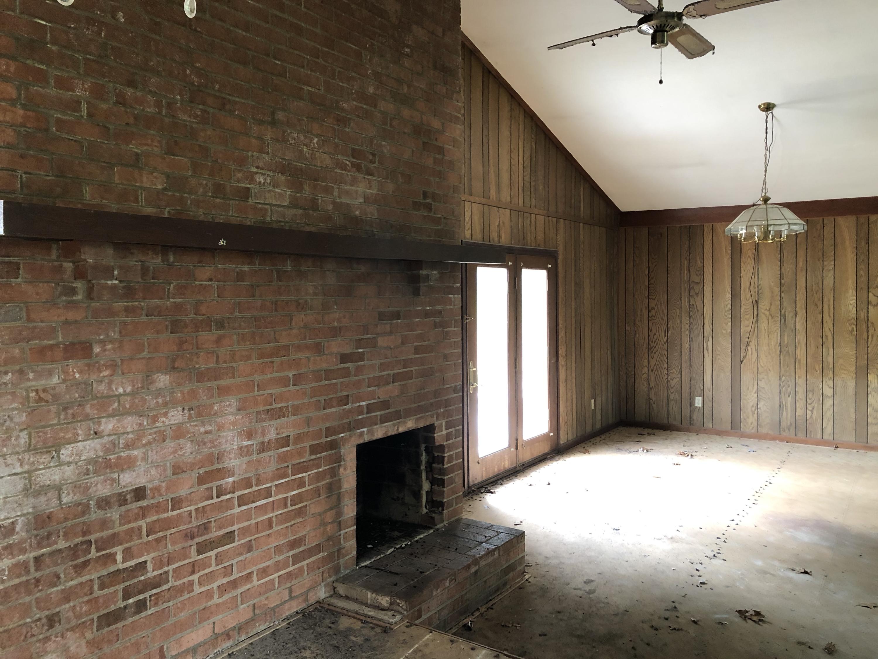 1764 Blue Ridge Springs Road Blue Ridge, VA 24064 - Photo 7 of 19 a view of a livingroom with a fireplace and a chandelier fan