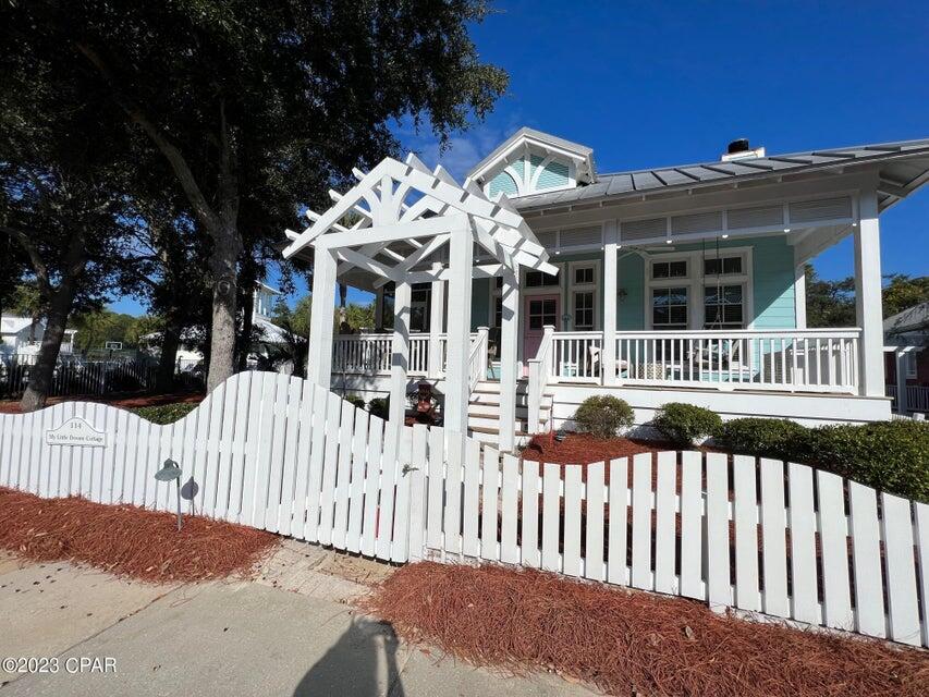 a view of a house with wooden fence