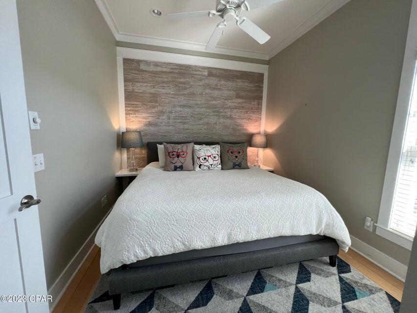 114 Parkshore Drive Panama City Beach, FL 32413 - Photo 21 of 86 a bedroom with a bed and a chandelier