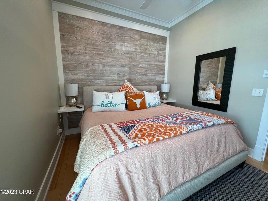 114 Parkshore Drive Panama City Beach, FL 32413 - Photo 25 of 86 a bedroom with a bed and wooden floor