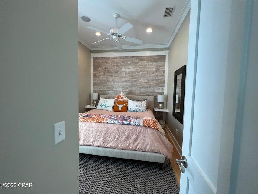 114 Parkshore Drive Panama City Beach, FL 32413 - Photo 26 of 86 a bedroom with a bed lamp and a window