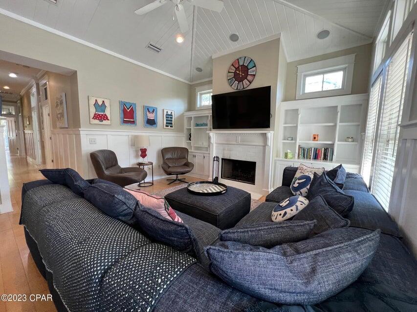 114 Parkshore Drive Panama City Beach, FL 32413 - Photo 3 of 86 a living room with furniture a flat screen tv and a fireplace