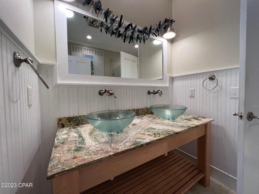 114 Parkshore Drive Panama City Beach, FL 32413 - Photo 33 of 86 a bathroom with a granite countertop sink a mirror and vanity