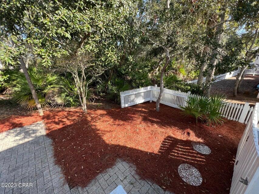 114 Parkshore Drive Panama City Beach, FL 32413 - Photo 39 of 86 a backyard of a house with table and chairs